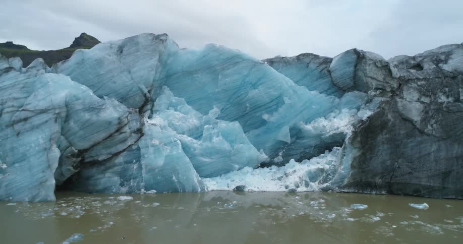 A giant ice wall sits by the mountain