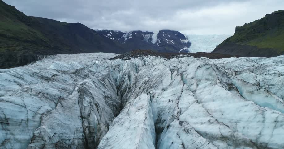 Ice and snow covered rocks sit in the middle of a canyon