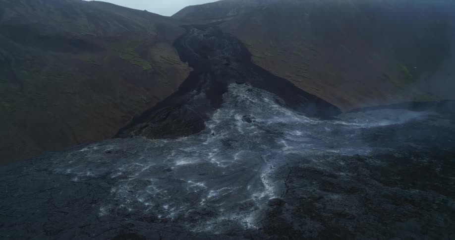 Smoke rises from cooled ash from volcanic eruption and lava flow