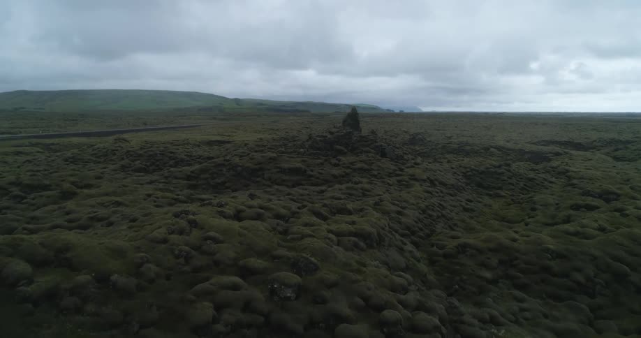 Thick cloud cover over vast hills of rocky terrain in the wilderness