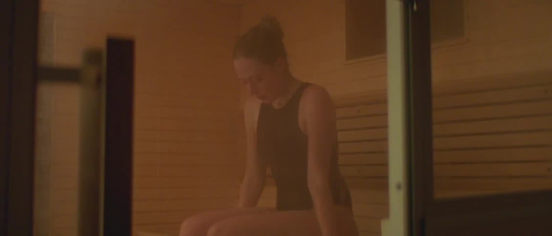 A woman sitting in a room thinking