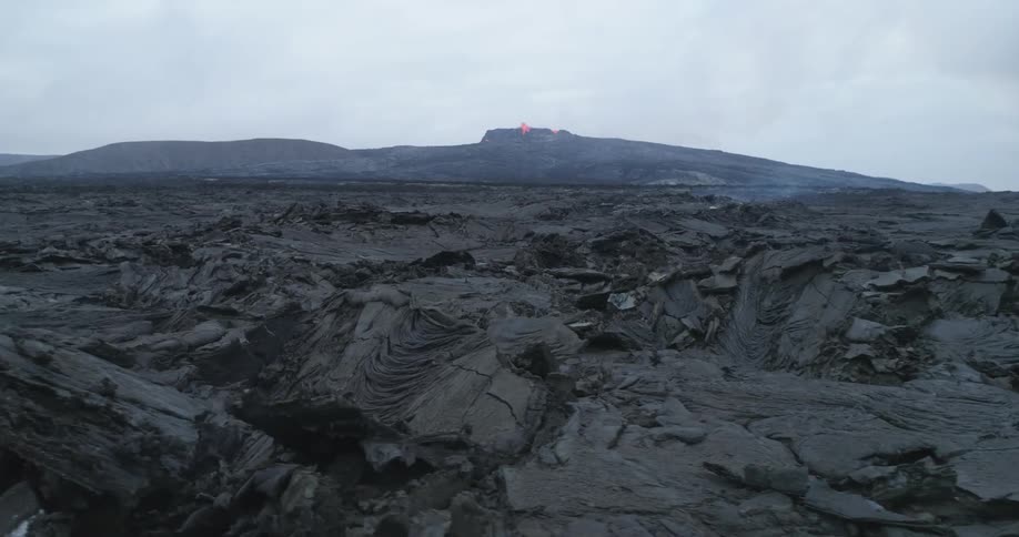 Lava erupts from a low volcano