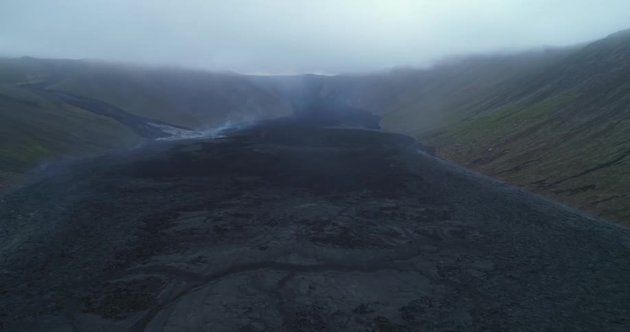 An aerial view of steam rising off a volcano