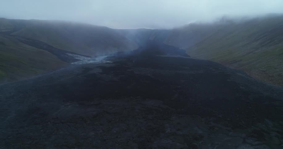 A river of lava rock is cooling near the volcano