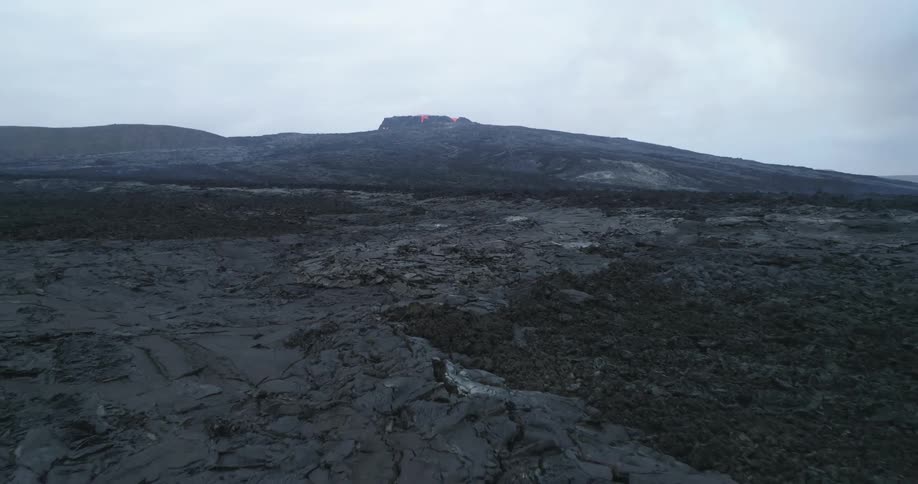 The volcano is erupting in the distance