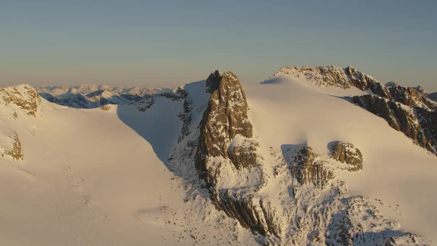 Mountain tops peek through a blanket of thick snow