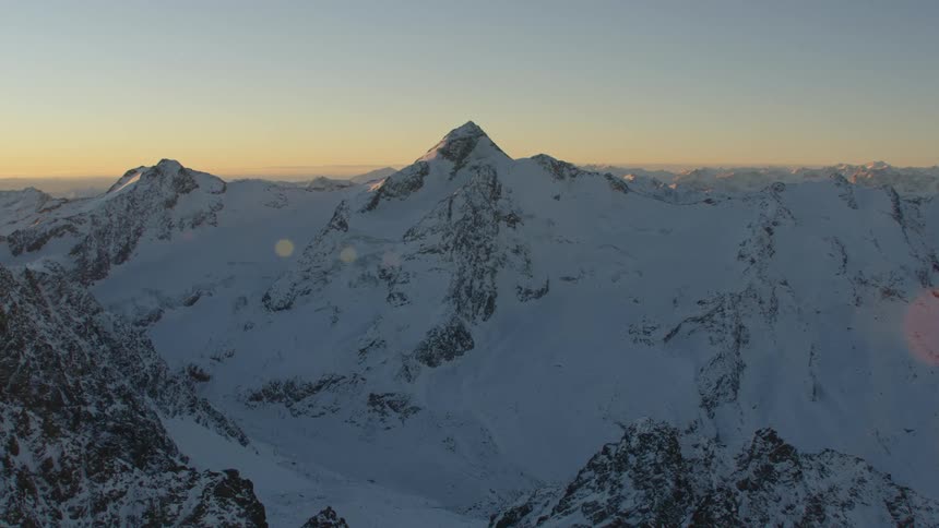 An aerial view of a mountain range covered in snow