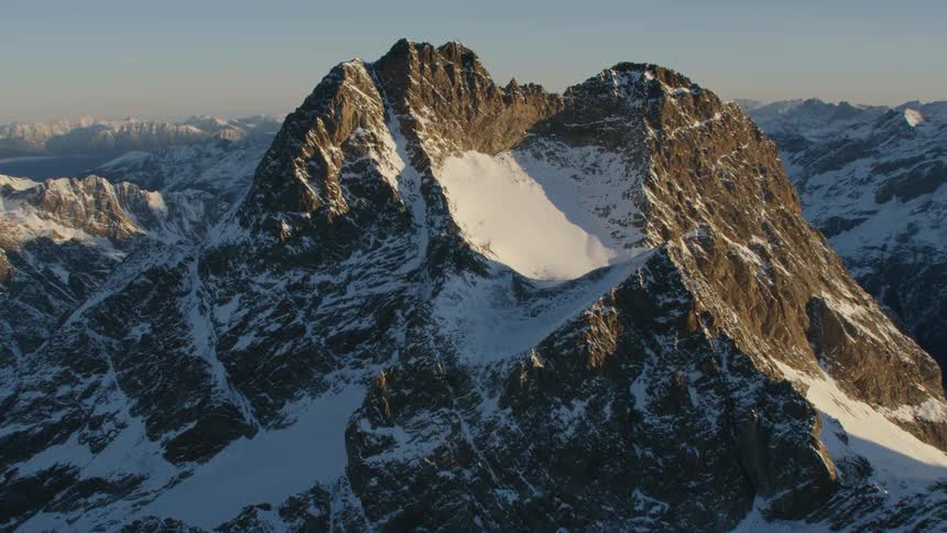 A snow dusted jagged mountain peak