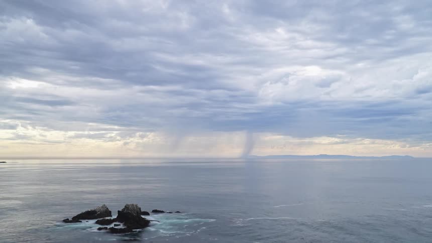 Ship moves across water near horizon as waves flow around rocks before warning image flashes