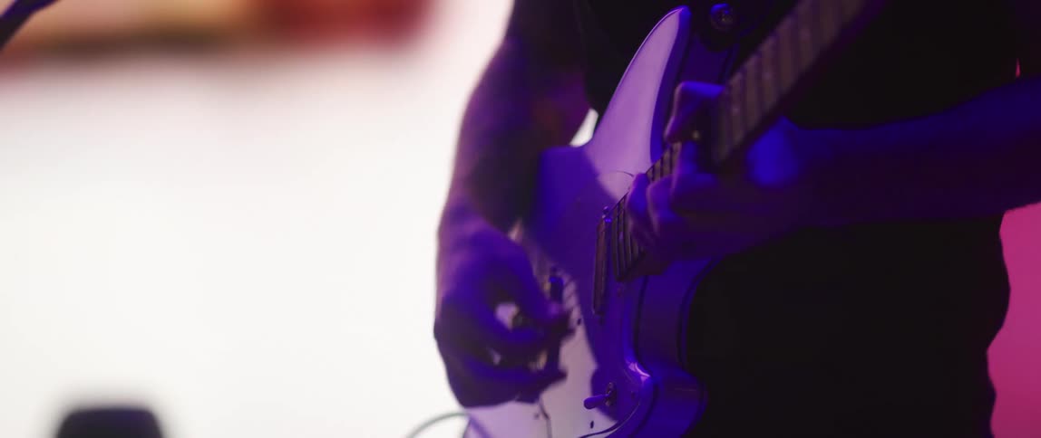 A person playing guitar on a stage