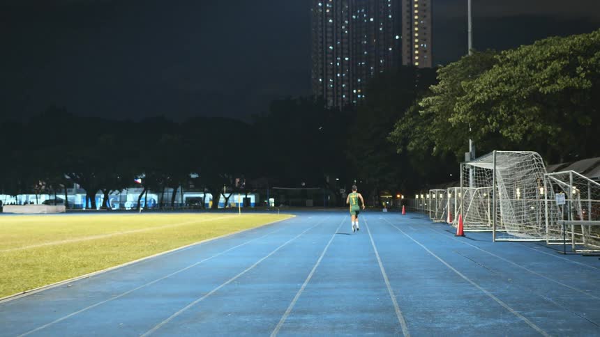 A man races on the track in the park