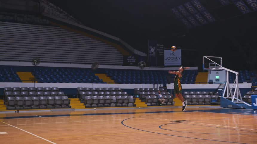 A man hitting a volleyball indoors