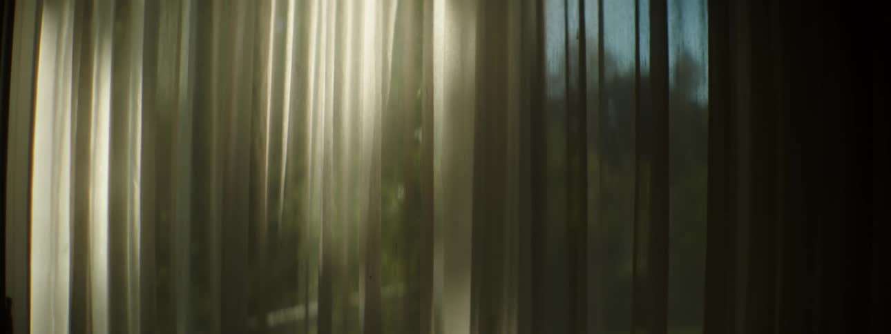 A drape is covering the window in the dark room