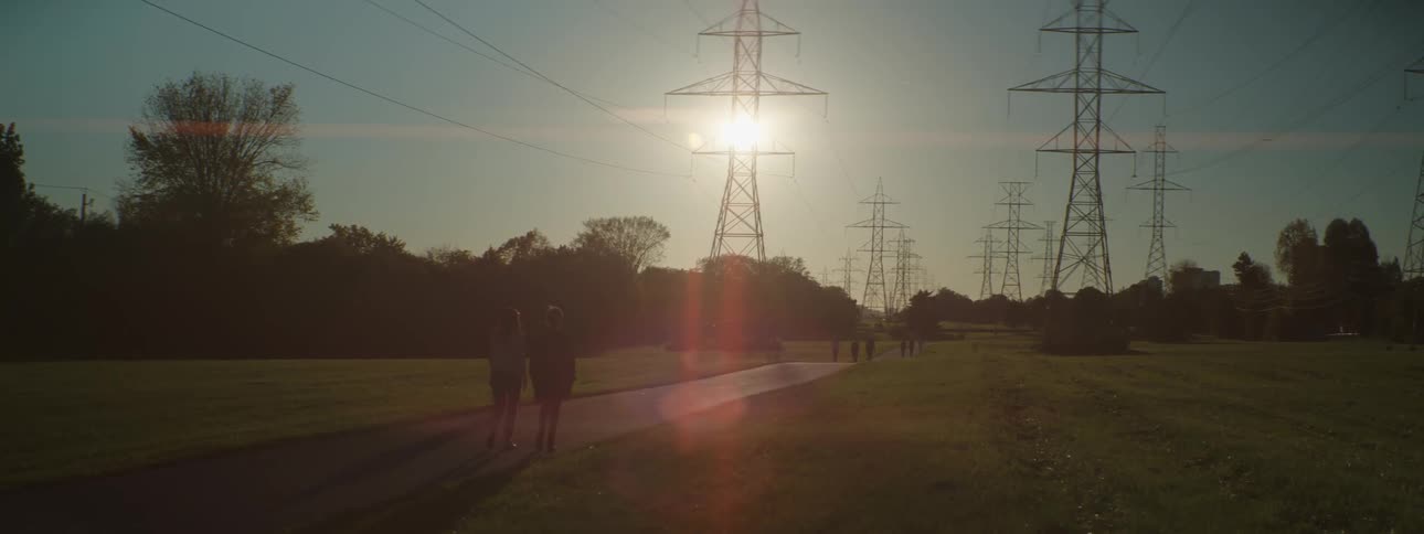 A group of people walking and riding bikes on a path