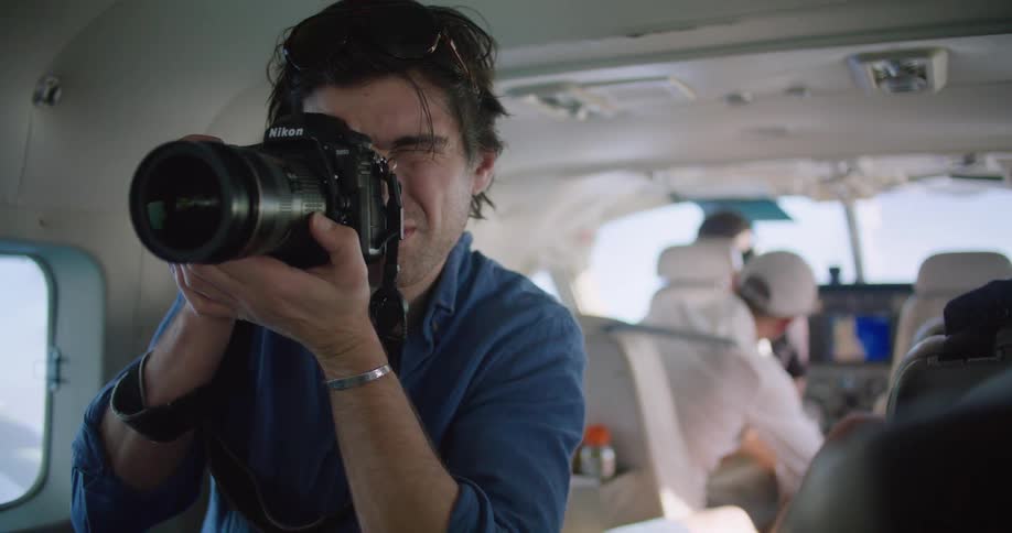 Person taking photo on a plane