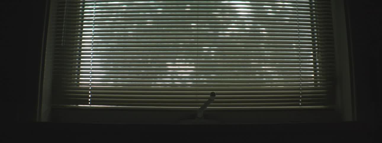 Closed window blinds on a window inside a room in a house
