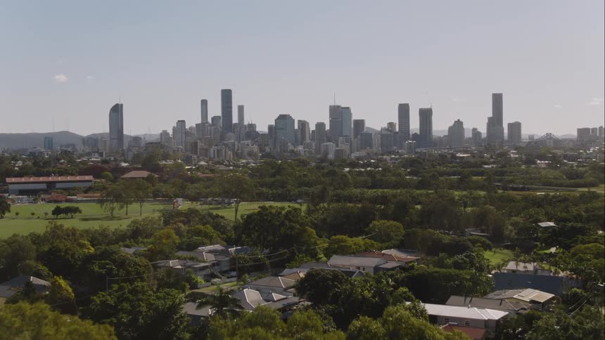 Aerial view of a neighborhood in front of the skyline of a city