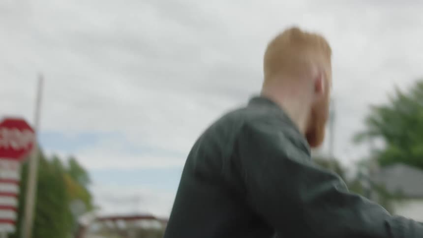A man getting into a car driven by a woman