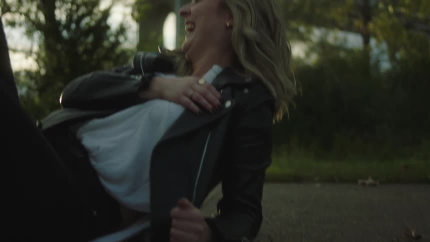 A man and woman eating food and having fun outdoors
