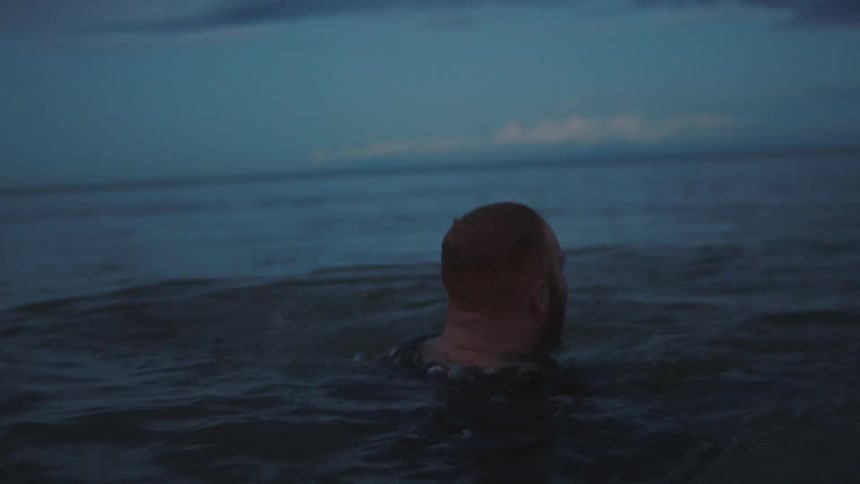 A man and woman playing in the ocean