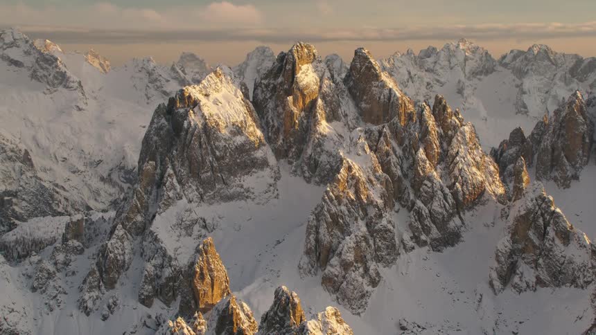 Mountain tops peak through a thick blanket of snow