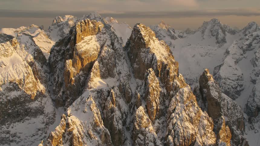An aerial view of mountains covered in snow