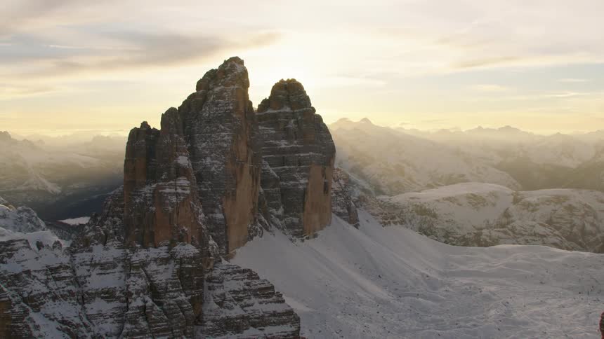 An aerial view of mountains covered in snow