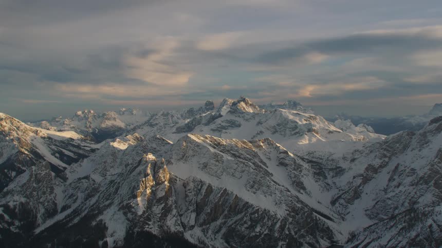Sunlight shines off the peaks of an icy mountain range