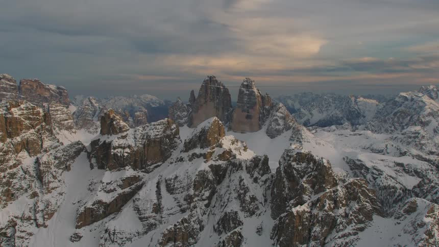 An aerial view of a large mountainous landscape on a cloudy day