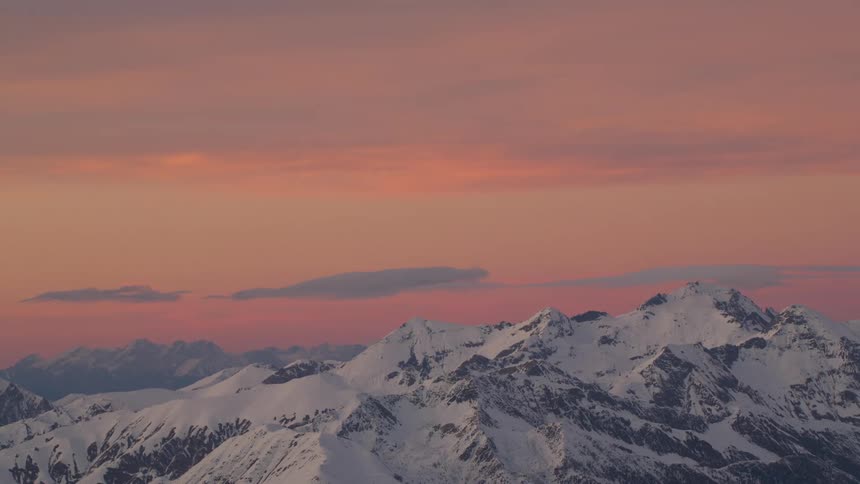 The sky is red at sunset on the mountain range
