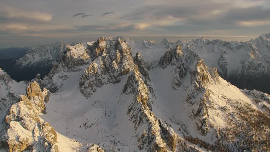 An aerial view of mountains covered in snow