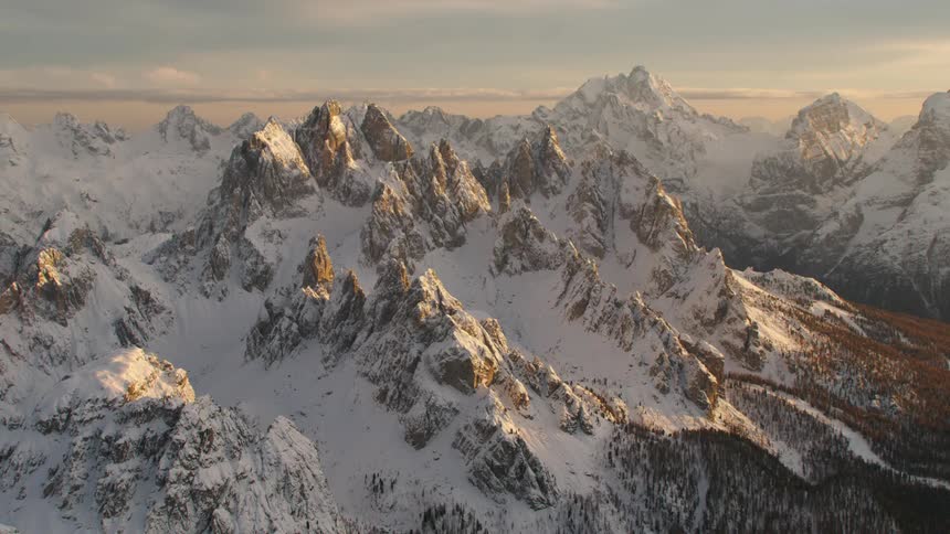 Snow covered mountains with peaks high in the sky