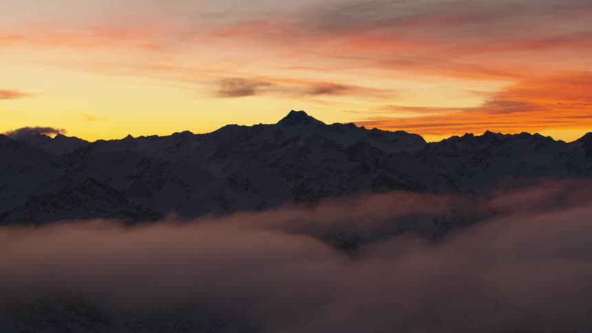An aerial view of a mountain range at sunset