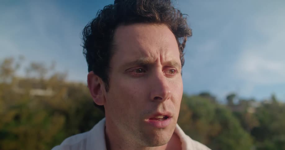 A man is outside and he seems to be thinking about something seriously