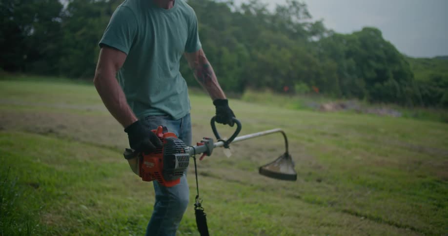 A man starting up a weed wacker