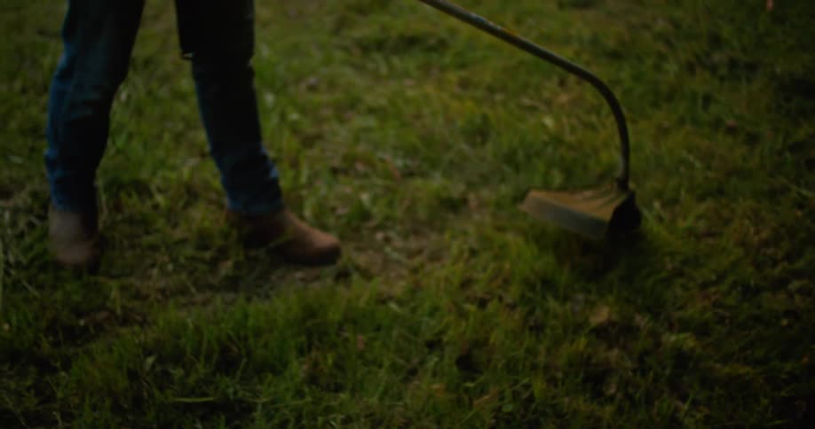 A man using a weed wacker outdoors