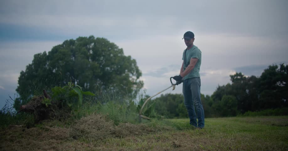 A man using a weed wacker outdoors