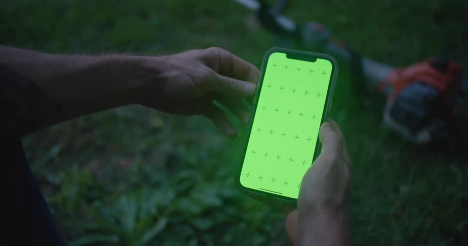 Someone is holding a phone with a green screen in both hands