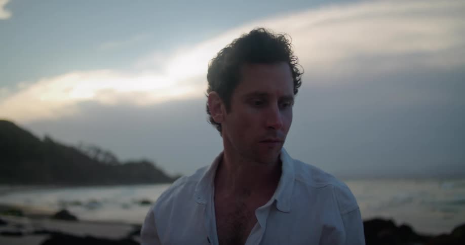 A man standing outdoors at the beach
