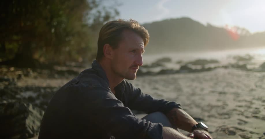 A man sitting on the beach thinking