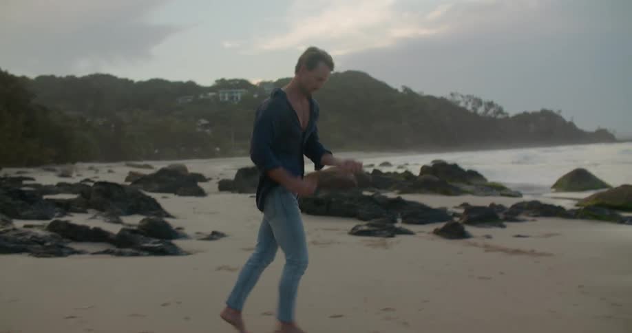 A man runs towards the ocean