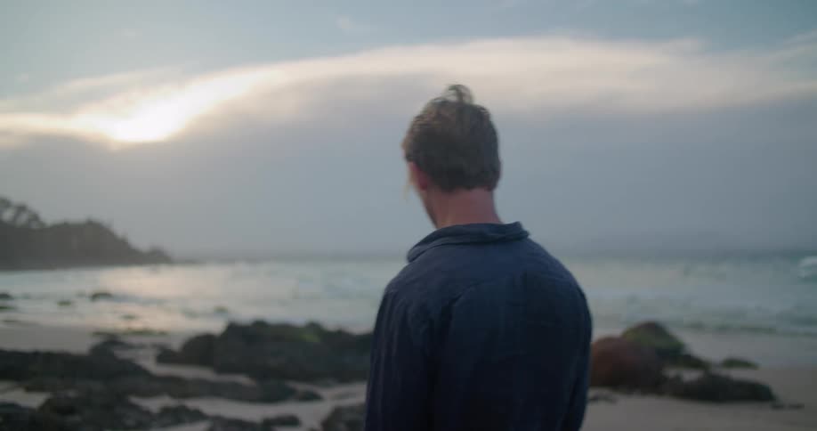 A man walking out on the beach
