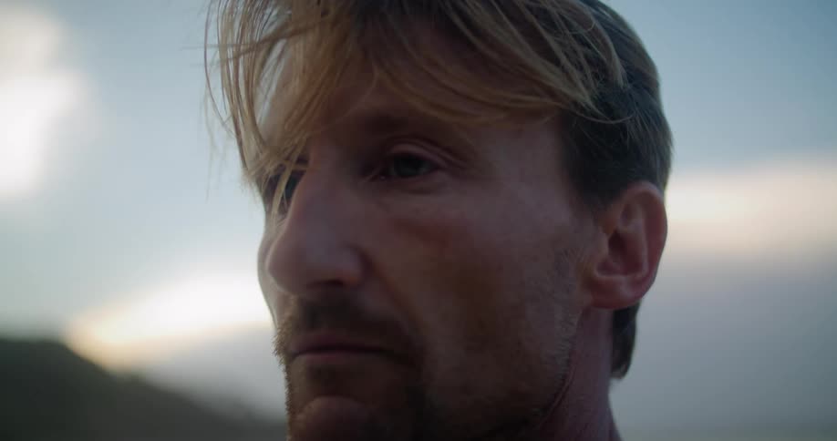 A man closes his eyes as he stands outside