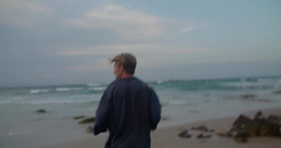 A man is running on the beach