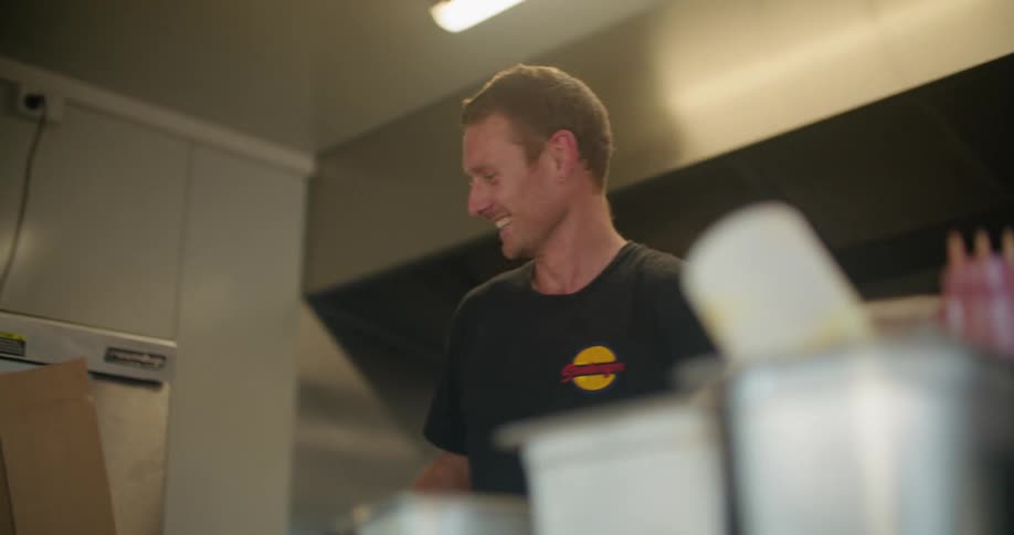 A man handing food over a counter