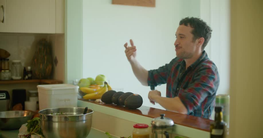 Man samples scent of dish cooking in skillet