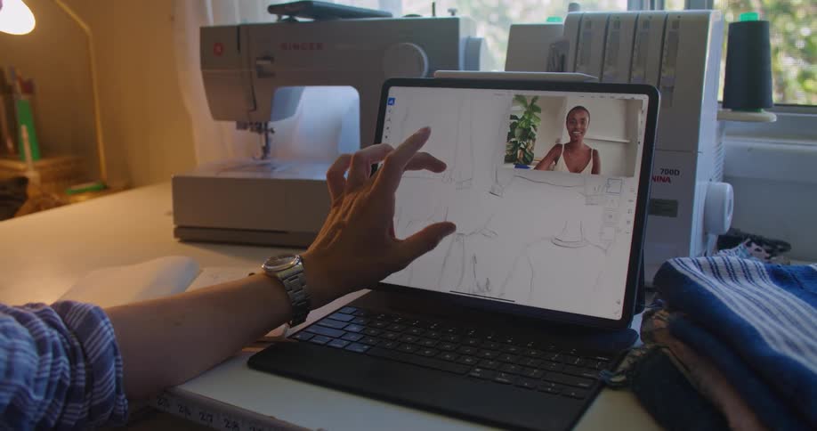 Man reviewing patterns on a laptop talks to a client on a video call