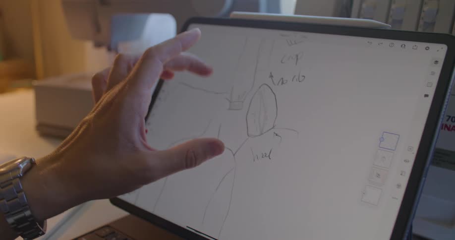 A person is looking at a drawing on the tablet