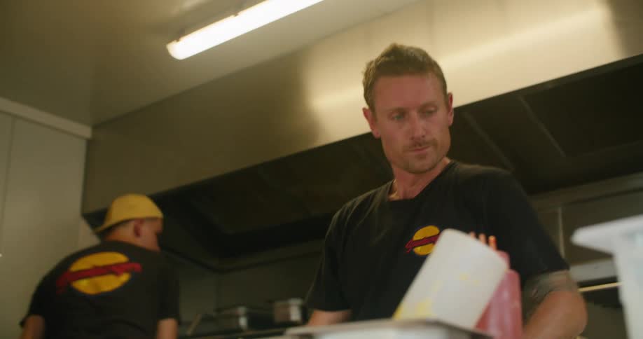 Two men work in the kitchen of a restaurant