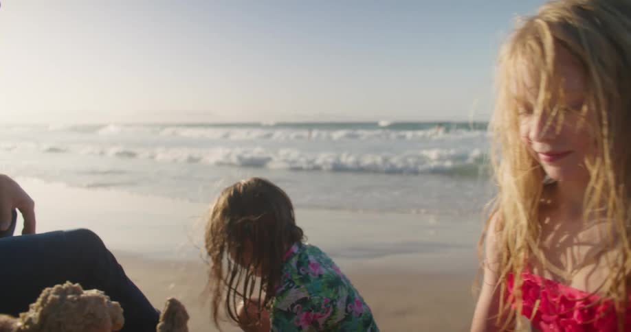Children build a sand castle on the beach